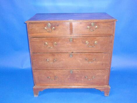 A George III chest of two short and three long graduated drawers with brass