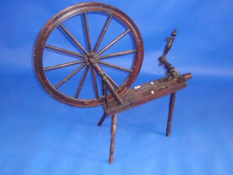 A 19th century beech and elm spinning wheel