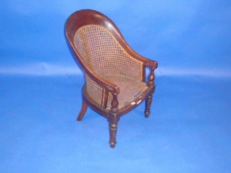 An early Victorian mahogany child's chair with cane seat and back