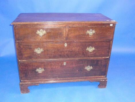 A George III oak chest of two short and two long graduated drawers with