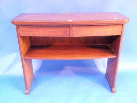 A modern rosewood bow front serving table