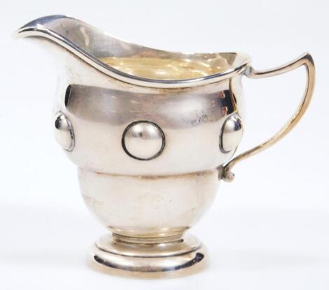 An Edwardian silver Arts & Crafts cream jug