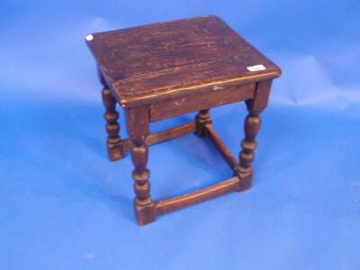 An antique oak joint stool