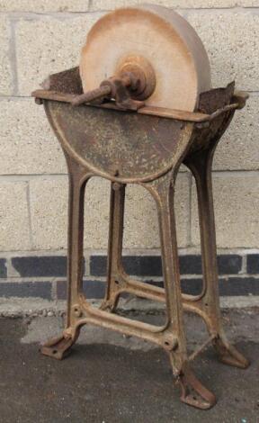 A late 19thC sharpening stone on cast metal stand