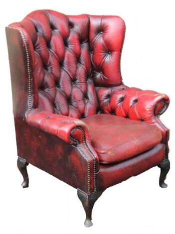 A 20thC red leather club wing armchair