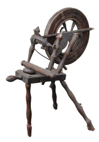 A turned wooden spinning wheel