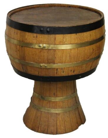 A 20thC oak and coopered barrel style pub table