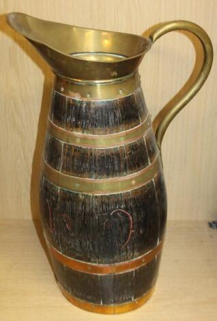 An early 20thC stained oak coopered brass flagon