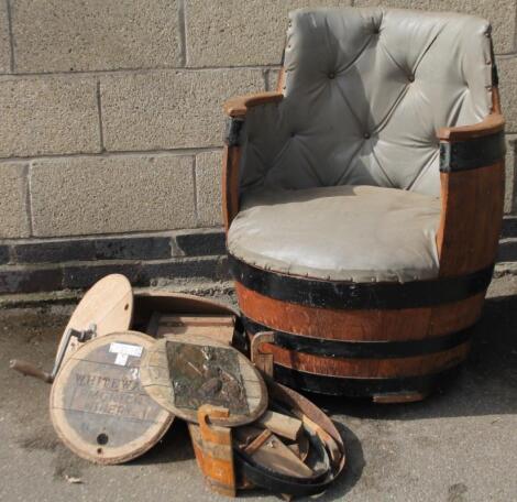 An early 20thC coopered barrel cut in the form of a tub chair