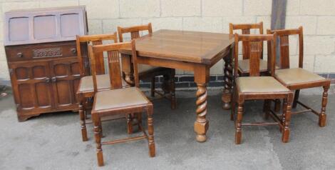 An early 20thC oak finish dining suite