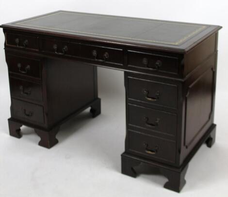 A 20thC mahogany finish twin pedestal writing desk