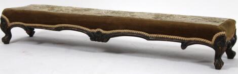 A 19thC stained walnut overstuffed long foot stool