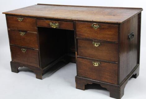 A late 19thC oak plank top pedestal desk