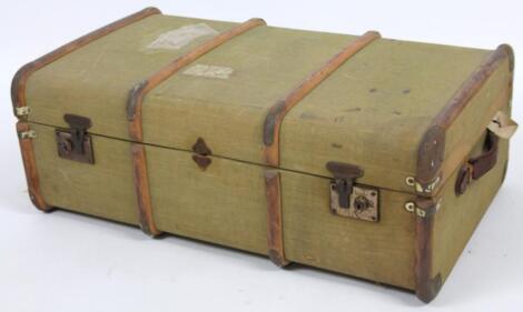 An early 20thC canvas and part wooden bound travel trunk