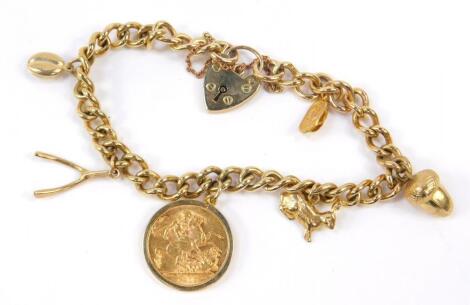 A George V gold full sovereign 1912 on a 9ct gold curb link charm bracelet