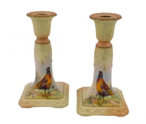 A pair of Locke & Company Ltd Worcester porcelain candlesticks