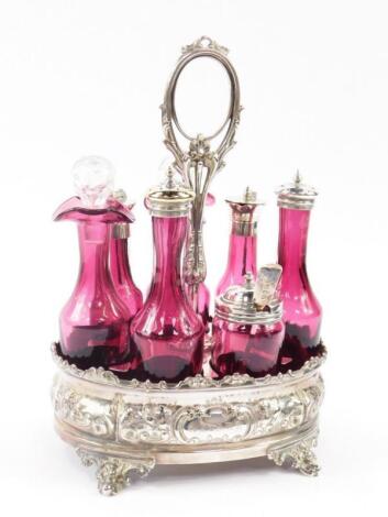 A Victorian silver plate and cranberry glass seven bottle cruet