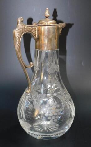 A silver and cut glass claret jug