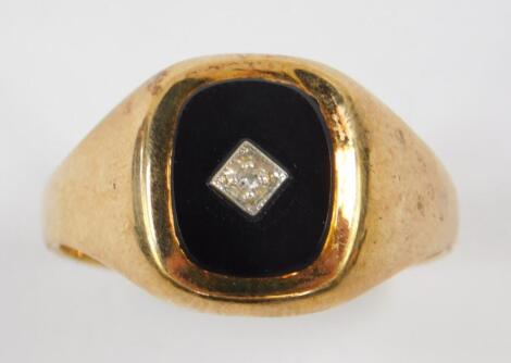 A gentleman's 9ct gold black onyx and diamond set signet ring