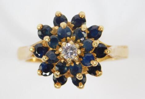 A sapphire and diamond three tier flower head ring