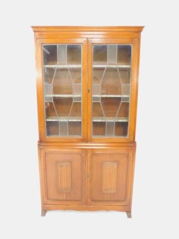 An early 20thC oak cupboard bookcase