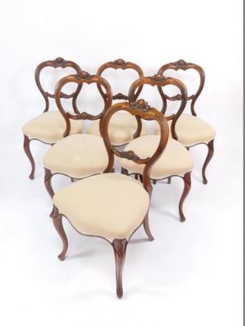 A set of six Victorian walnut balloon back dining chairs