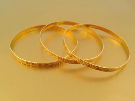 Three matching engraved bangles marked 22A