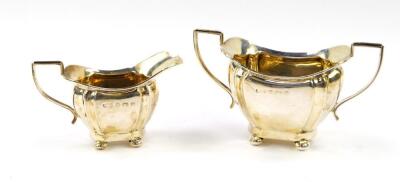 A George V silver fluted cream jug and sugar bowl