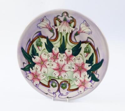 A Moorcroft pottery charger decorated in the Blakeney Mallow pattern