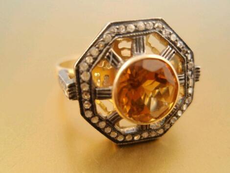 A Celtic design ring of central round faceted citrine in yellow