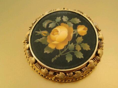 A circular micro mosaic brooch of a yellow rose and foliage in a yellow metal frame