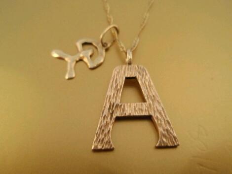 A letter A pendant and chain stamped 9ct