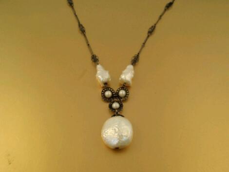 An interesting early 20thC pierced metal necklace with baroque style pearl beads