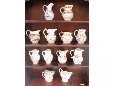 A set of 12 Royal Worcester reproduction creamers in a modern mahogany finished wall shelf