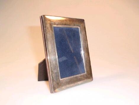 A modern silver photograph frame of rectangular form