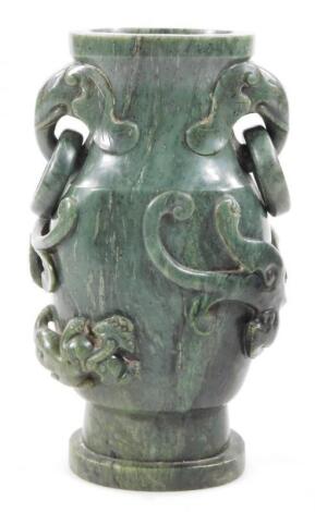 A polished jade coloured stone vase