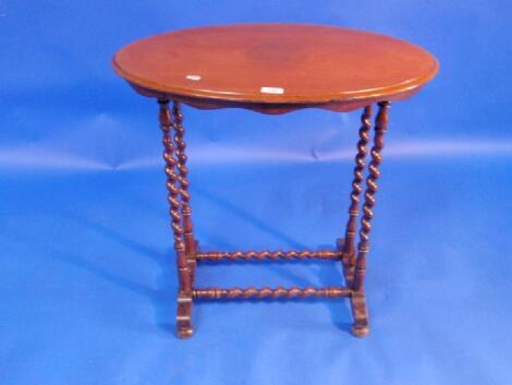 A Victorian walnut occasional table with oval moulded top