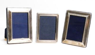 Three similar Elizabeth II silver fronted photograph frames