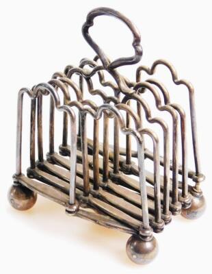 An early 20thC fold away Concertina action toast rack