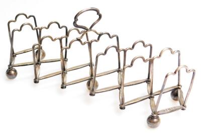 An early 20thC fold away Concertina action toast rack - 2