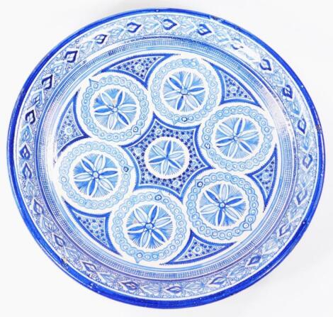 A 17thC style Islamic pottery blue and white charger