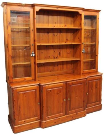 A Ducal pine breakfront display cabinet