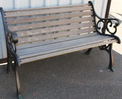 A cast metal and wooden slatted garden bench