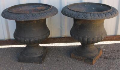 A pair of cast iron classical urn planters