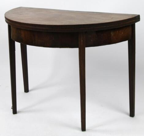 An early 19thC mahogany D-end fold over table