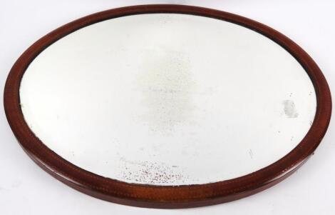 An Edwardian mahogany and boxwood strung oval mirror