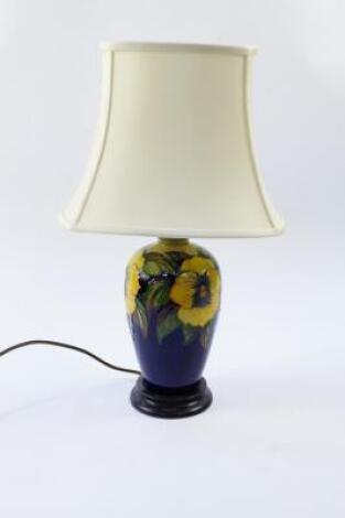 A Moorcroft Pottery table lamp decorated in the Golden Pansy pattern