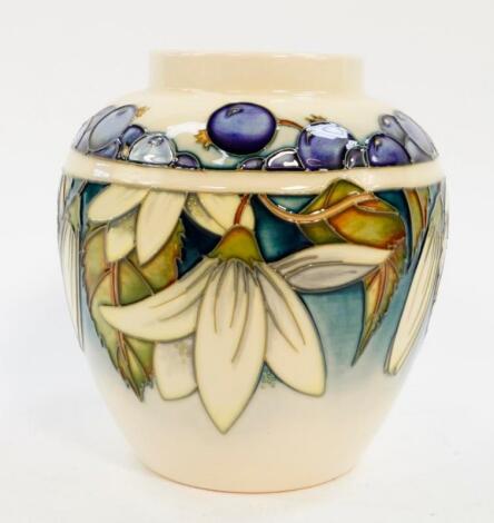 A Moorcroft Pottery vase decorated in the Juneberry pattern