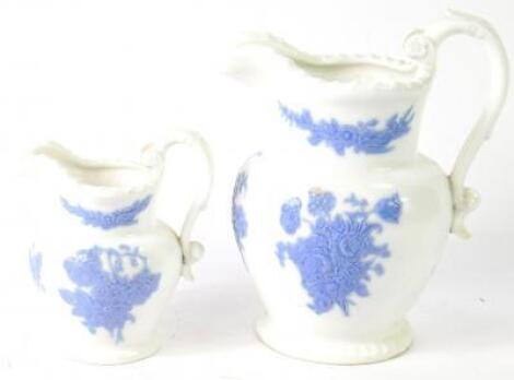 A pair of early 19thC porcelain graduated jugs