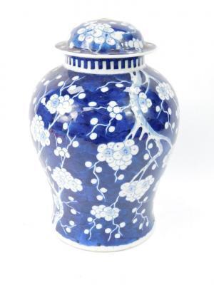 A Qing porcelain ginger jar and cover decorated with prunus blossom against a cracked ice ground